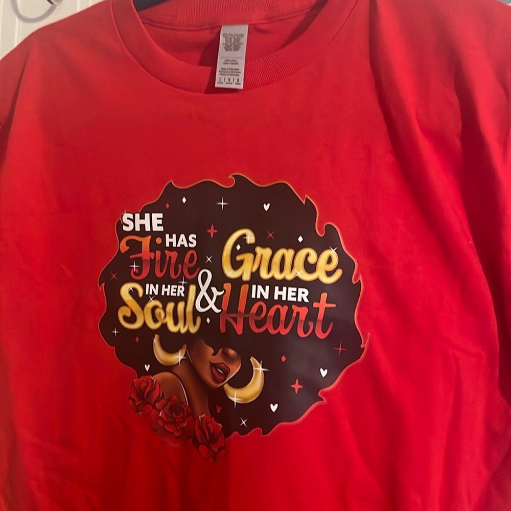 A large youth, red t-shirt with a beautiful colorful image.